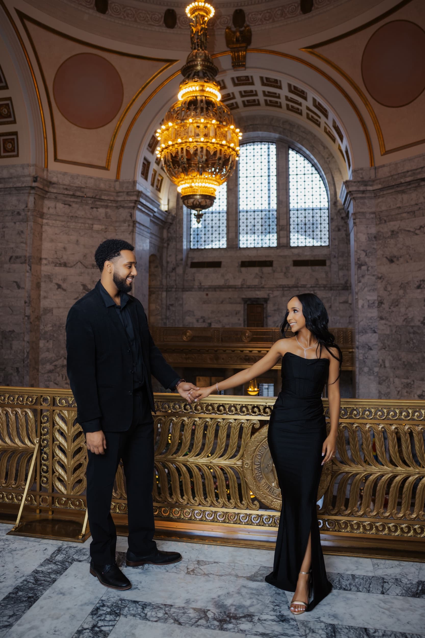 Kaleb and Hermela beneath a grand gold chandelier